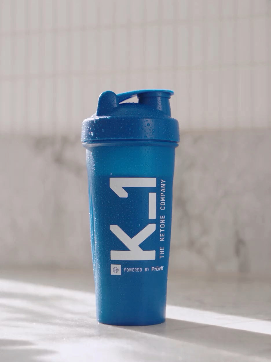 A K_1 shaker bottle beaded with condensation on a kitchen counter